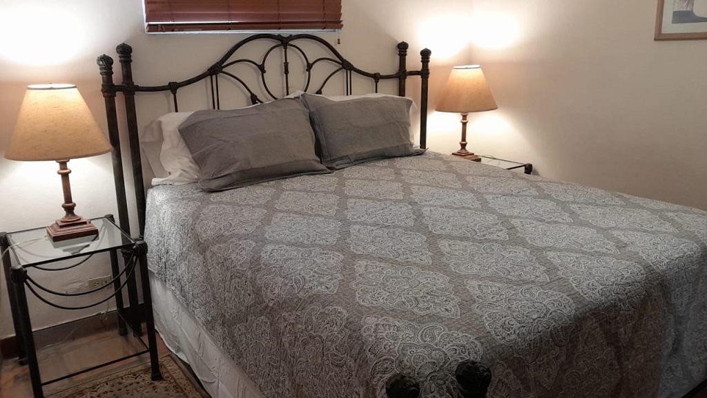 king bed in one of the downstairs bedrooms of circa del mar